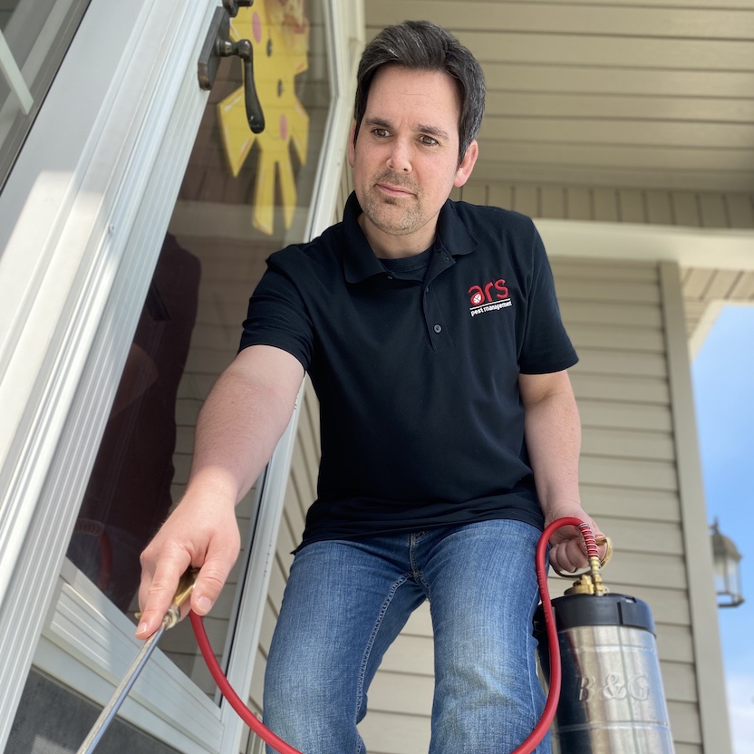 Pest control specialist performs exterior service